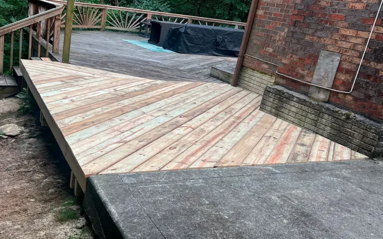 a wooden deck with a brick wall and a brick building