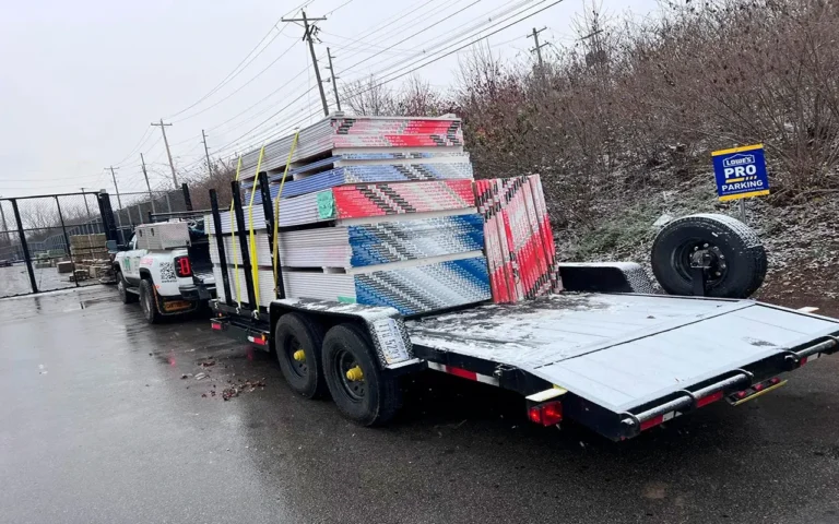 a truck with a trailer full of construction material